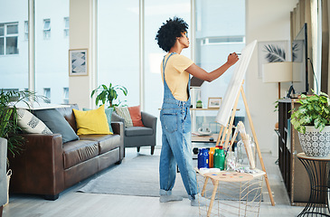 Image showing I paint to relax my mind. a young artist painting on a canvas at home.