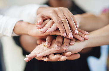 Image showing Creating a strong foundation for success to thrive from. Closeup shot of a group of businesspeople joining their hands together in an huddle.