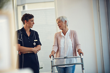 Image showing Shes found a helping hand and a listening ear. a senior woman having a discussion with a young female nurse while using a walker in a nursing home.