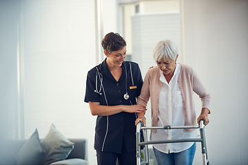 Image showing Youre doing so great. a young nurse assisting a senior woman walk using a walker in a nursing home.