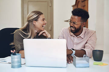 Image showing Theyre such an ace team. two businesspeople laughing while working together in an office.