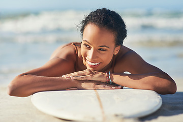 Image showing This is exactly what I needed. a young woman out at the beach with her surfboard.