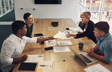 Image showing Here you go. a group of business colleagues sitting around a table in the boardroom during a meeting.