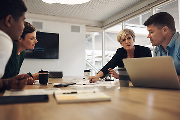 Image showing Lets talk it over. a group of business colleagues sitting around a table in the boardroom during a meeting.