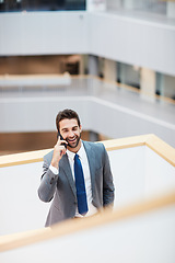 Image showing Lets meet up and make it happen. a young businessman talking on a cellphone in an office.