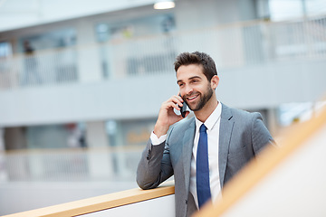 Image showing Im on my way to you right now. a young businessman talking on a cellphone in an office.