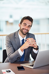 Image showing Hard work is so vital to ensuring success. Portrait of a young businessman working on a laptop in an office.