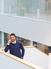 Image showing Hi, do you have a minute to talk. a young businessman talking on a cellphone in an office.