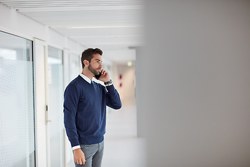 Image showing This is something we should talk about face-to-face. a young businessman talking on a cellphone in an office.