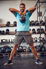 Image showing The battle is only against yourself. Full length portrait of a handsome young man working out with a kettle bell in the gym.