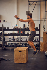 Image showing Jumping just got a little tougher. Full length shot of a handsome young man box jumping while working out in the gym.