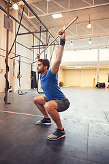 Image showing Work your body like never before. Full length shot of a handsome young man working out with a stick in the gym.