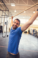 Image showing Always challenge yourself. Cropped portrait of a handsome young man working out in the gym.