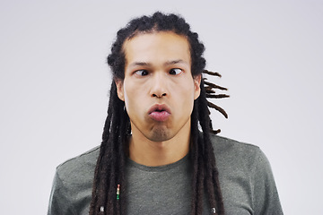 Image showing There’s a time for being normal…that time’s not now. Studio shot of a young man making a funny face against a gray background.