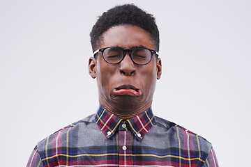 Image showing Because life would be boring without a bit of fun. Studio shot of a young man making a funny face against a gray background.