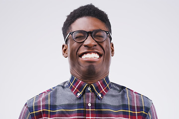 Image showing Fun comes first. Studio shot of a young man making a funny face against a gray background.