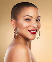 Image showing Happy girls are the prettiest. Studio shot of a beautiful young woman posing against a brown background.