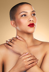 Image showing Youre everything they said youre not. Studio shot of a beautiful young woman posing against a brown background.