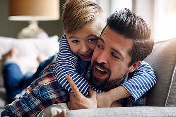 Image showing Big hugs for the bestest Dad. a father and his little son bonding together at home.