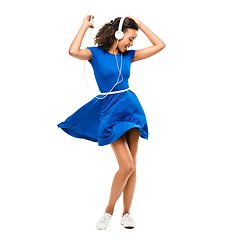 Image showing Dance like it could be your last. a beautiful woman dancing a blue dress against a studio background.