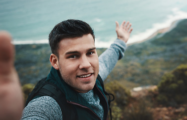 Image showing You cant be bored in a world as beautiful as this. a young man taking selfies while out on a hike.