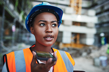 Image showing Leveraging new technology for large scale construction. a young woman using a smartphone while working at a construction site.