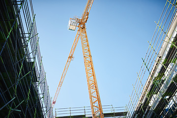 Image showing The city is rising up. a crane and building at a construction site.