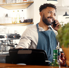 Image showing Placing orders has never been easier. a young waiter taking an order via his smartphone.