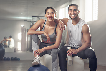 Image showing Hit the gym and bring your partner along. two young athletes sitting together at the gym.