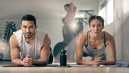 Image showing Skipping gym is not even a option. two young athletes working out together at the gym.