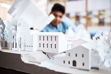 Image showing The best building design in the business. an architect designing a building model in a modern office.