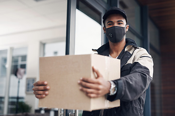 Image showing In times of uncertainty you can count on our service. a masked young man delivering a package to a place of residence.