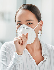 Image showing Covering your mouth is more than just good manners. a masked young businesswoman coughing in a modern office.