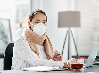 Image showing Lets do what we need to do to keep going. a masked young businesswoman using a laptop at her desk in a modern office.