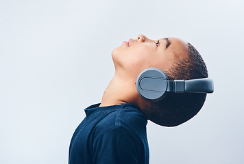 Image showing Lean back and let the music take over. Studio shot of a cute little boy using headphones against a grey background.