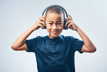 Image showing Good sounds make you feel good. Studio shot of a cute little boy using headphones against a grey background.