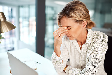 Image showing Work anxiety throwing you off balance and leaving you stressed. a mature businesswoman looking stressed out while working in an office.