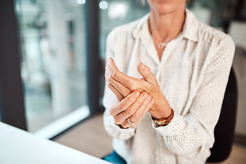 Image showing Dealing with hand pain and stiffness. Closeup shot of an unrecognisable businesswoman experiencing discomfort in her hand while working in an office.