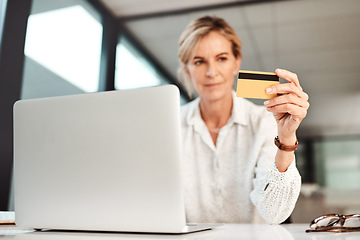 Image showing Now you can manage your businesss money 247. a mature businesswoman using a laptop and credit card in an office.