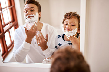 Image showing Heres how dad manages to look ten years younger. a man teaching his young son how to shave at home.