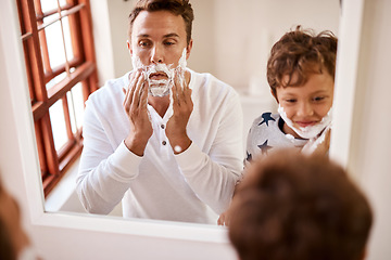 Image showing Teaching your kid to shave is no small task. a man teaching his young son how to shave at home.