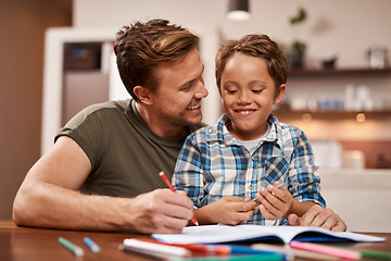 Image showing Your presence and support creates a positive learning environment. a man sitting with his son while he does his homework.