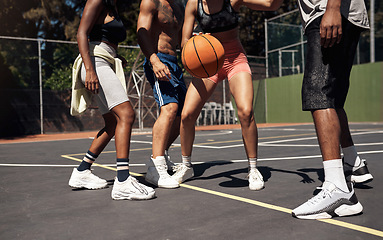 Image showing Basketball is all about balance and coordination. Closeup shot of a group of sporty young people playing basketball on a sports court.