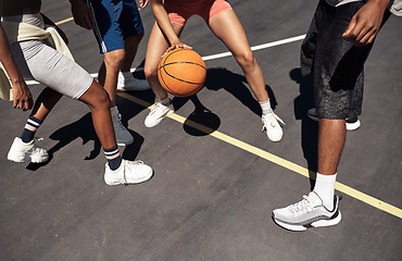 Image showing Showcasing some fancy footwork on the court. Closeup shot of a group of sporty young people playing basketball on a sports court.