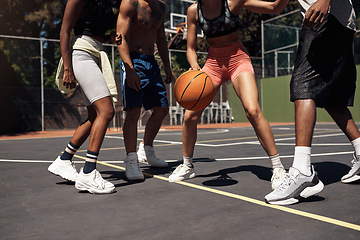 Image showing You have to be fast on your feet. Closeup shot of a group of sporty young people playing basketball on a sports court.