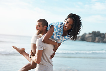 Image showing Enjoying their lovely little break away. a young couple enjoying some quality time together at the beach.