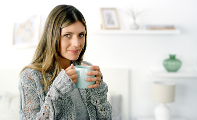 Image showing All you need is some free time and coffee. a woman enjoying a cup of coffee at home.