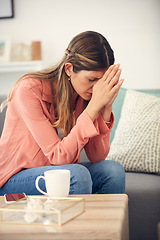 Image showing When you dont know what to do, pray. a young woman looking upset while sitting at home.