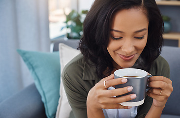 Image showing Coffee…you just get me. an attractive young woman having coffee and relaxing on the sofa at home.