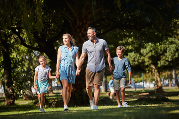 Image showing Family is the gift that keeps on giving. a happy young family going for a walk in the park.